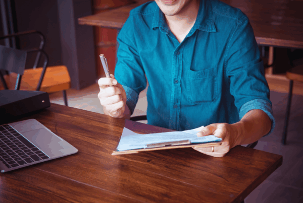 Difference between general liability and professional liability insurance explained for business owners reviewing documents at a desk