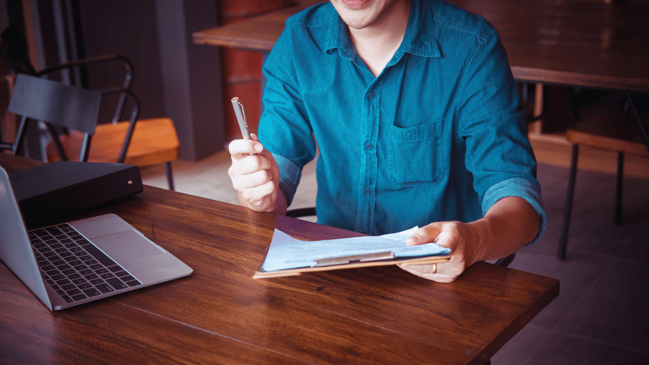 Difference between general liability and professional liability insurance explained for business owners reviewing documents at a desk