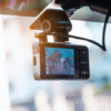 Dash cam installed on a car windshield capturing road conditions, illustrating the benefits of dash cams for drivers in Newfoundland and Labrador.