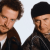 Two individuals dressed in winter clothing holding tools, used to illustrate the importance of securing your home before leaving for vacation.