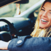 Driver seated in a parked car with the window open, illustrating peace of mind and confidence when choosing or switching car insurance.